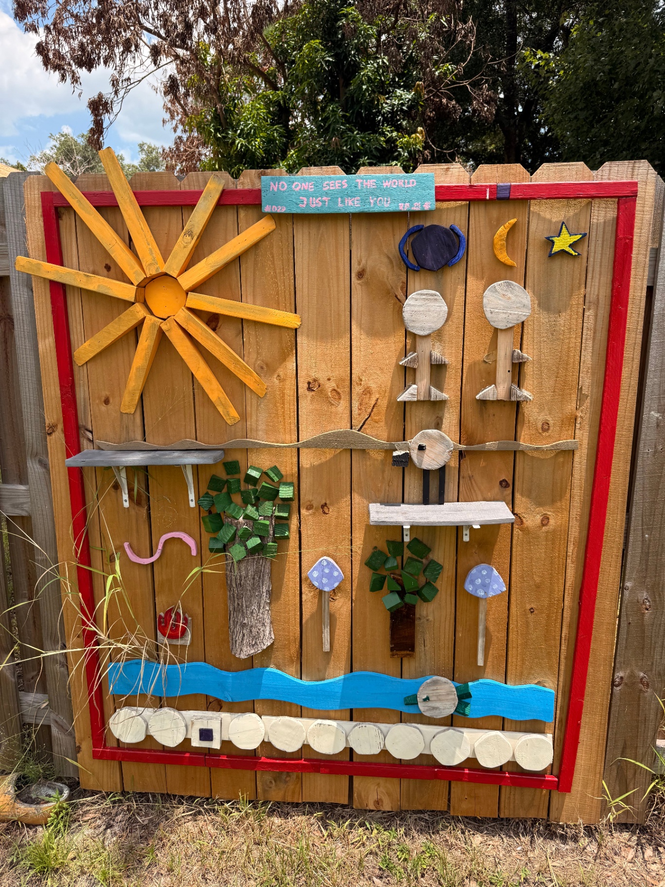 Wooden scene mural on a fence