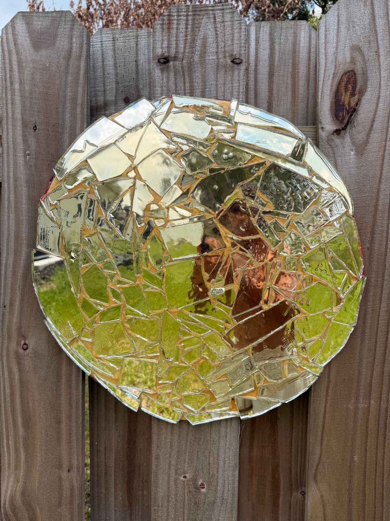 Circular mirror mosaic made of broken glass